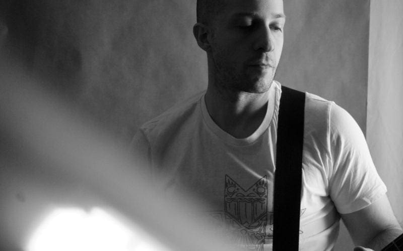 Man playing guitar black and white earns neighbouring rights