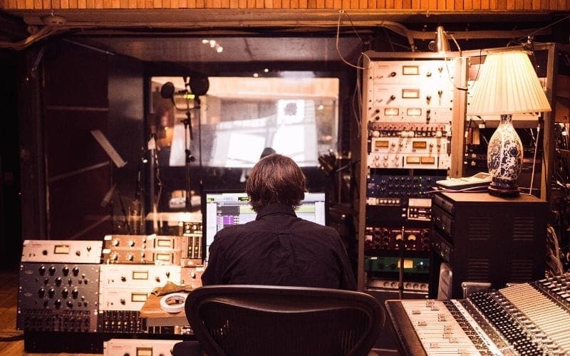 Music producer at mixing desk in best recording studio in London