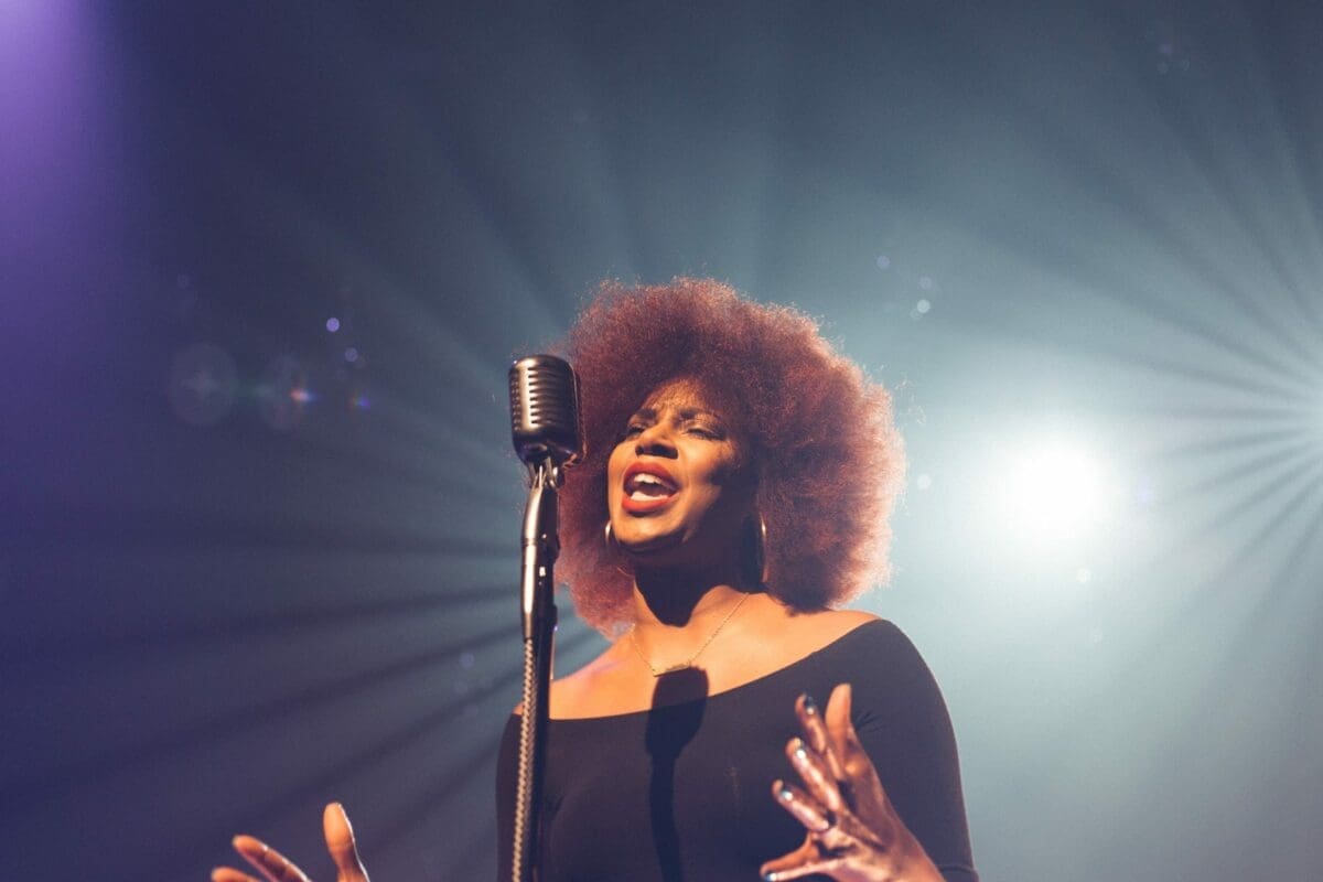 woman singing on stage