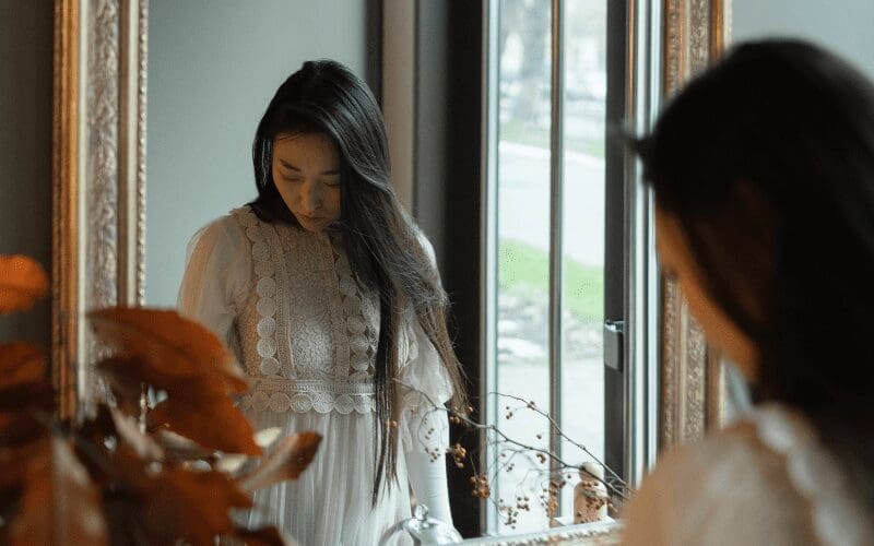 woman looking in the mirror