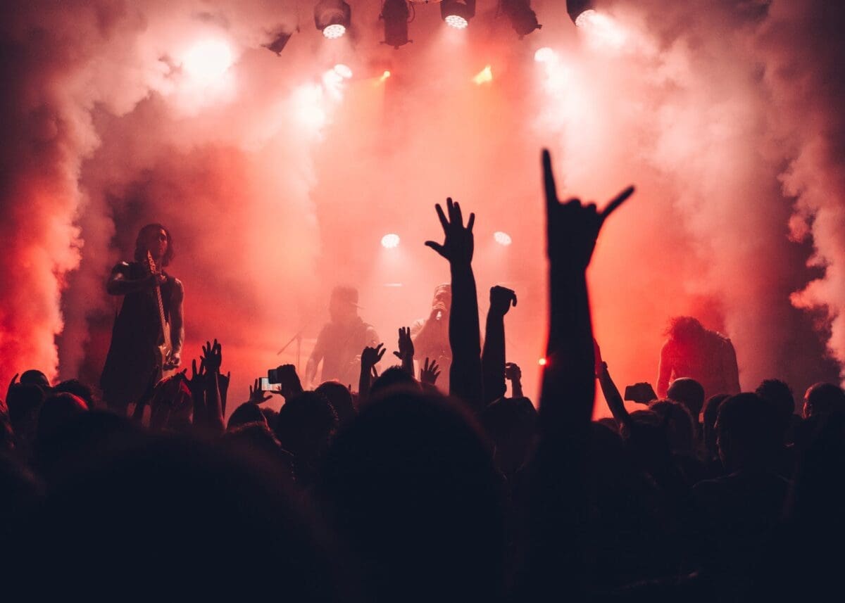 People at ADE/amsterdam dance event doing hand signs in the crowd.
