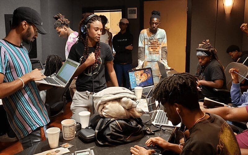 artists in a recording studio sending demo tape to record label