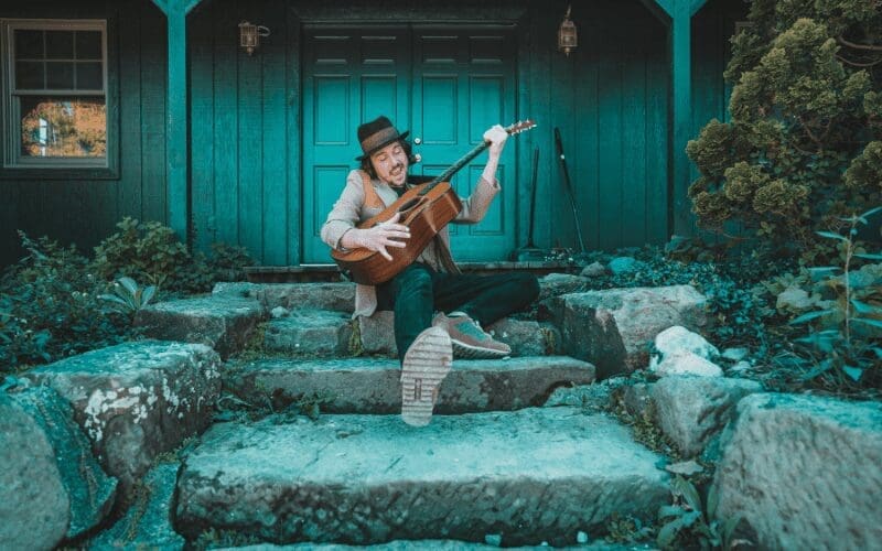 man having fun learning guitar
