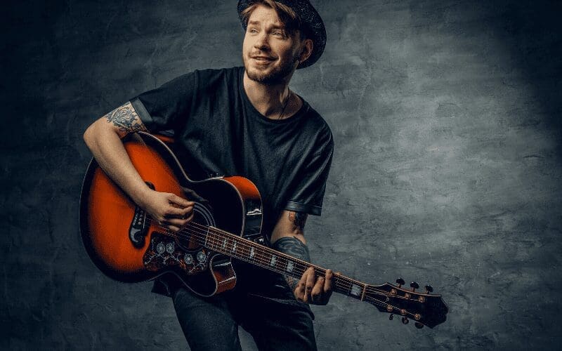 man learning guitar