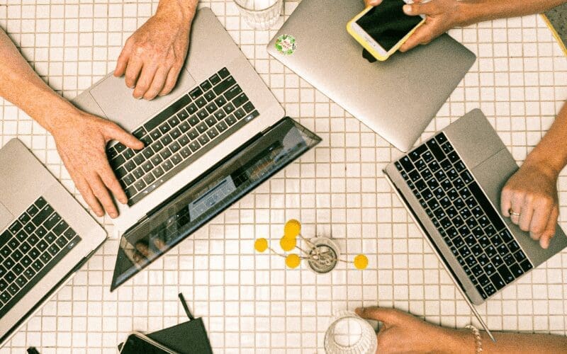multiple people on laptops