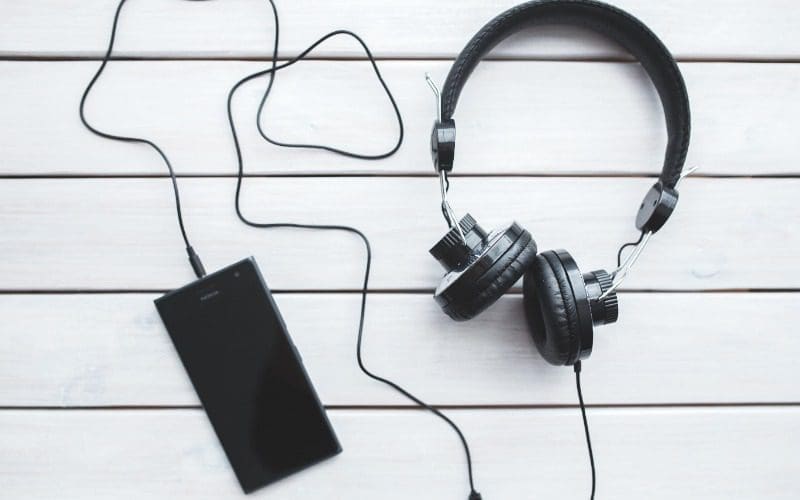 headphones plugged into a mobile phone